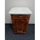 An early 20th century stained pine pot cupboard with marble top (a/f)