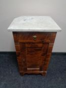 An early 20th century stained pine pot cupboard with marble top (a/f)