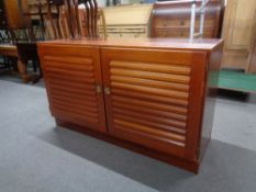 A pair of double door cabinets in a mahogany finish