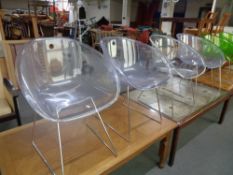 Four clear perspex Italian Pedrali ghost chairs on metal legs