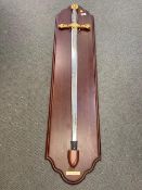 A large ornamental sword on wooden board - Excaliber