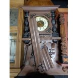 An early 20th century continental eight day wall clock with brass and enamelled dial in a painted