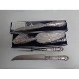A boxed silver handled bread knife and cake slice,
