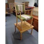 A blonde oak armchair and a lamp table