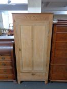 An antique stripped pine hall wardrobe