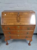 A walnut 1930's bureau on claw and ball feet