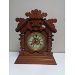 An antique mahogany and pine cased bracket clock with brass and enamelled dial by the Ansonia clock