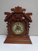 An antique mahogany and pine cased bracket clock with brass and enamelled dial by the Ansonia clock