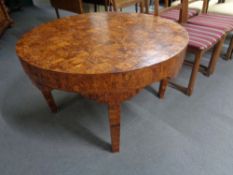 A continental circular bird's eye maple veneered checker board top coffee table