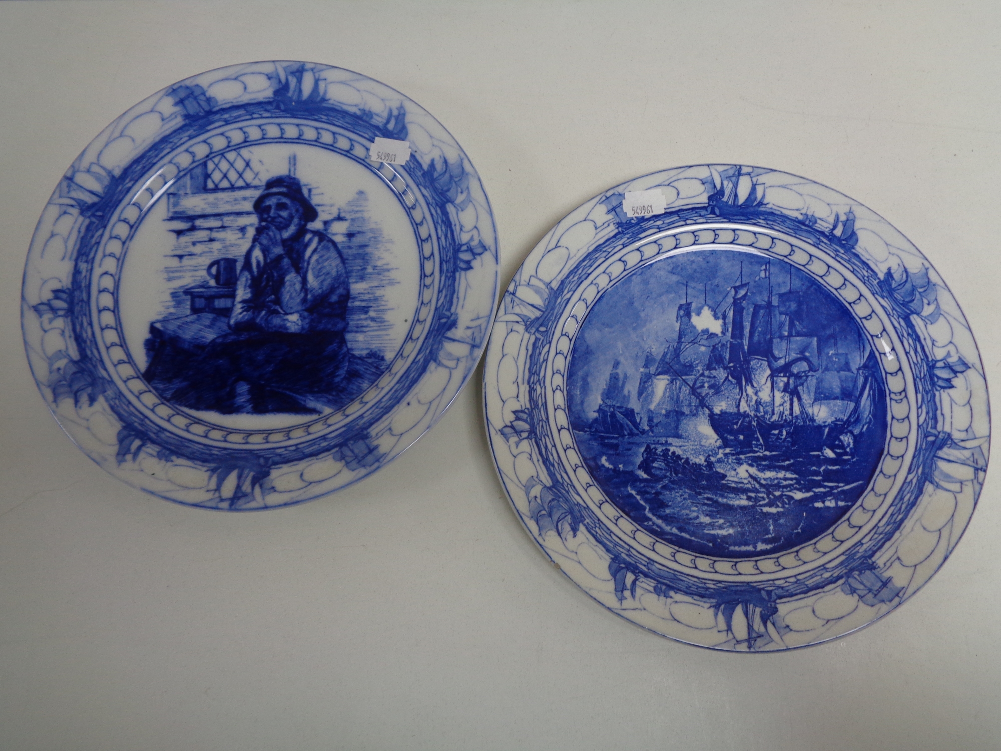 A pair of antique Royal Doulton blue and white plates - Battle of Trafalgar together with one other.