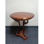A Malaysian circular occasional table on swan neck support