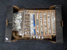 A box of china thimbles and thimble collector's cabinet