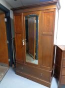 A late Victorian mirror door wardrobe