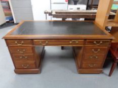 A Victorian mahogany twin pedestal desk, brass drop handles,