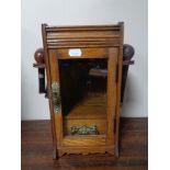 An Edwardian oak smokers cabinet with pipes