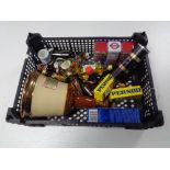 A basket of alcohol miniatures and a Bells whiskey decanter