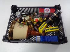 A basket of alcohol miniatures and a Bells whiskey decanter