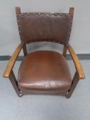 An Edwardian oak child's armchair in button leather