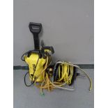 A Karcher pressure washer and a hose pipe on reel