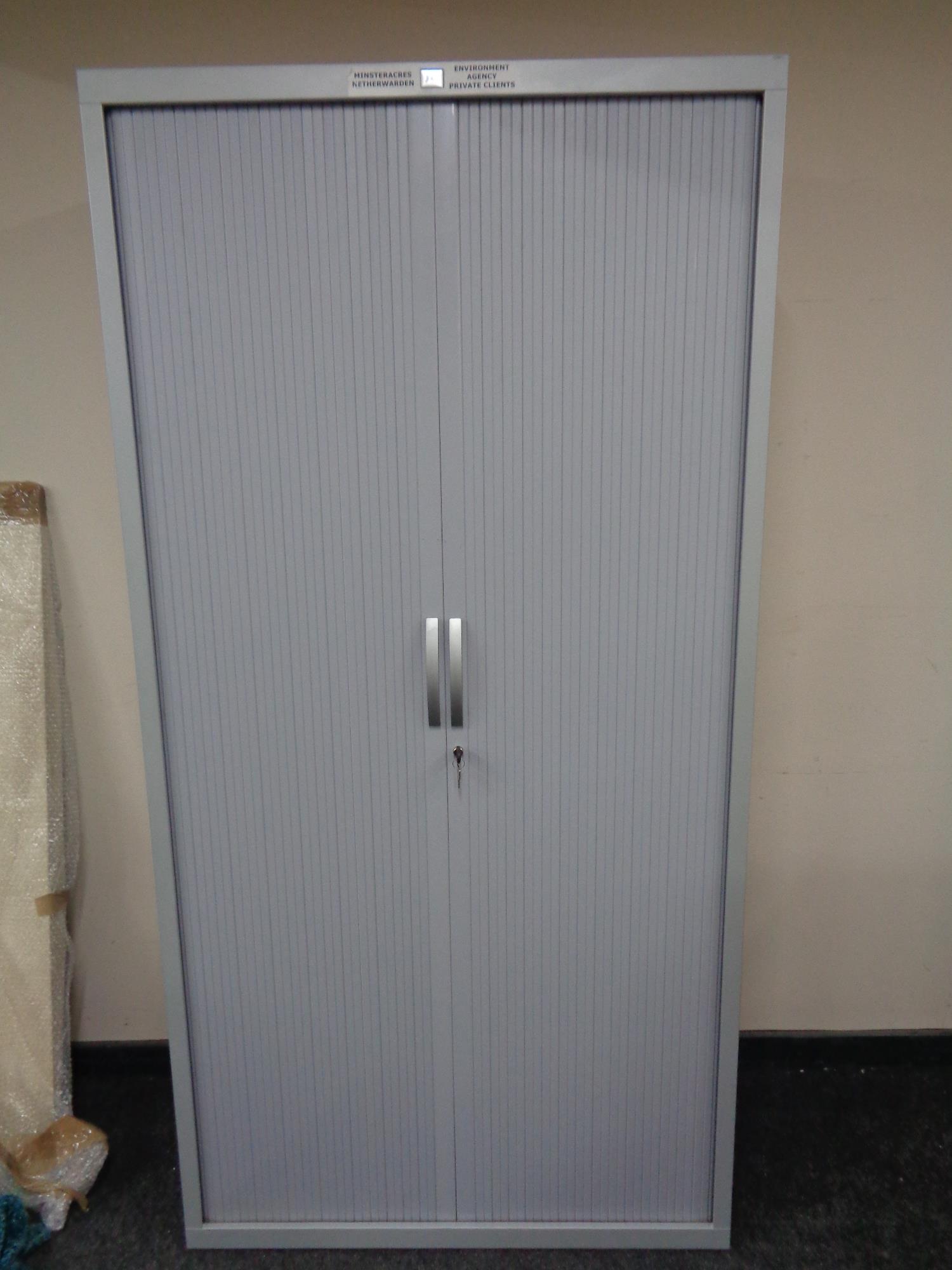 A J G Group metal shutter door stationery cabinet with keys,