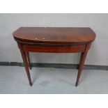 A George III inlaid mahogany turnover top table