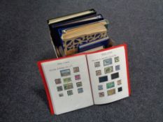 A box of ten folders and albums of stamps of the world