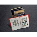A box of ten folders and albums of stamps of the world