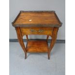 A reproduction French style bedside table with brass gallery and mounts
