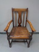 An Edwardian oak carver armchair