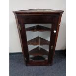 A nineteenth century oak glazed corner cabinet