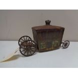 An antique Jacobs biscuit tin in the form of a state carriage