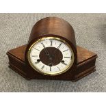 An Art Deco oak cased mantel clock with pendulum and key