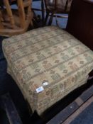 An upholstered footstool