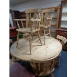 A pine farmhouse circular dining table and six antique style chairs
