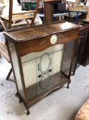 A walnut display cabinet fitted with a Smith's clock