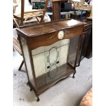 A walnut display cabinet fitted with a Smith's clock