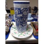 A blue and white stick pot and two ceramic chargers