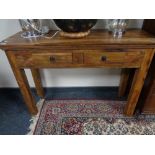 A sheesham wood side table fitted with two drawers