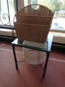 A metal glass topped lamp table together with a wicker magazine rack and light shade