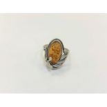 A Sterling silver ring set with amber