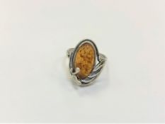 A Sterling silver ring set with amber