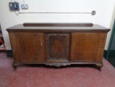 An early 20th century continental sideboard with walnut panel inset