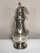 A large silver sugar caster