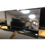 A Samsung 40" LCD TV (wall mounted no stand) and remote