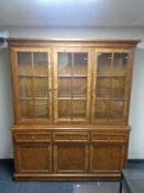 A John Lewis "Hemingway" antique style glazed three door bookcase fitted with cupboards and drawers