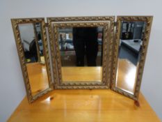 A decorative gilt framed dressing table mirror