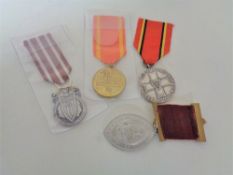 Four Polish medals with ribbons.