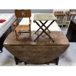 An antique oak gate leg table,