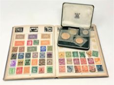 An album of world stamps and a Guernsey proof coin set 1966