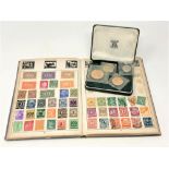 An album of world stamps and a Guernsey proof coin set 1966